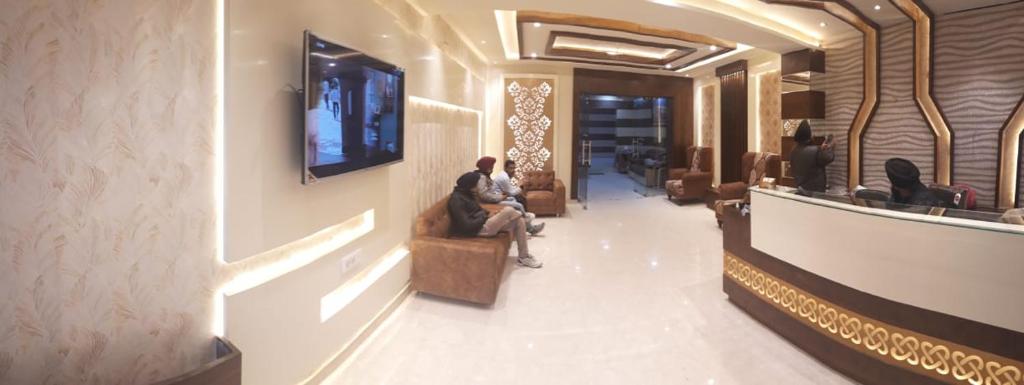 a man sitting on a couch in a lobby at Hotel Seeta Since 1965 in Amritsar