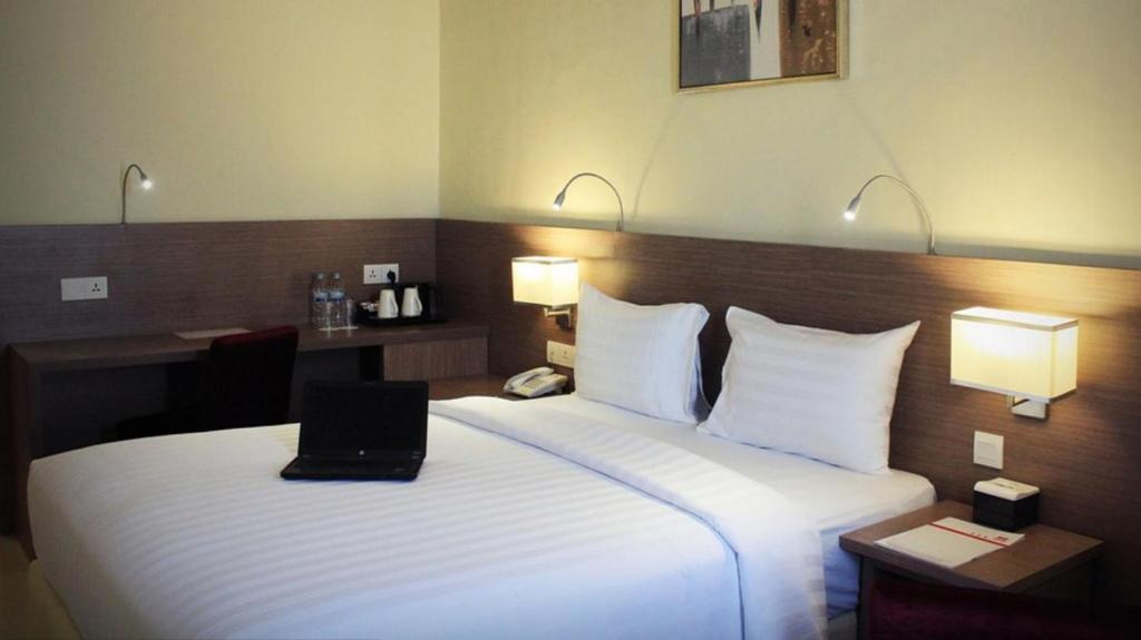 Postel nebo postele na pokoji v ubytování Biz Hotel Batam