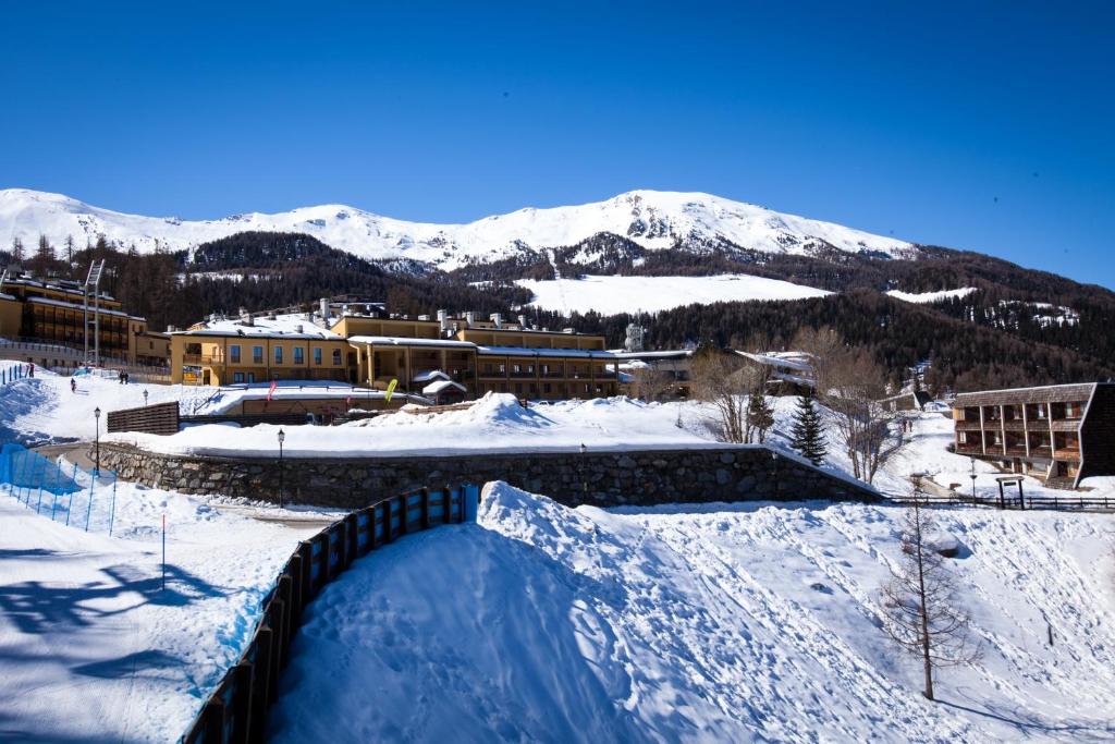 a snow covered skate park in front of a mountain at Club Esse Pila 2000 in Pila