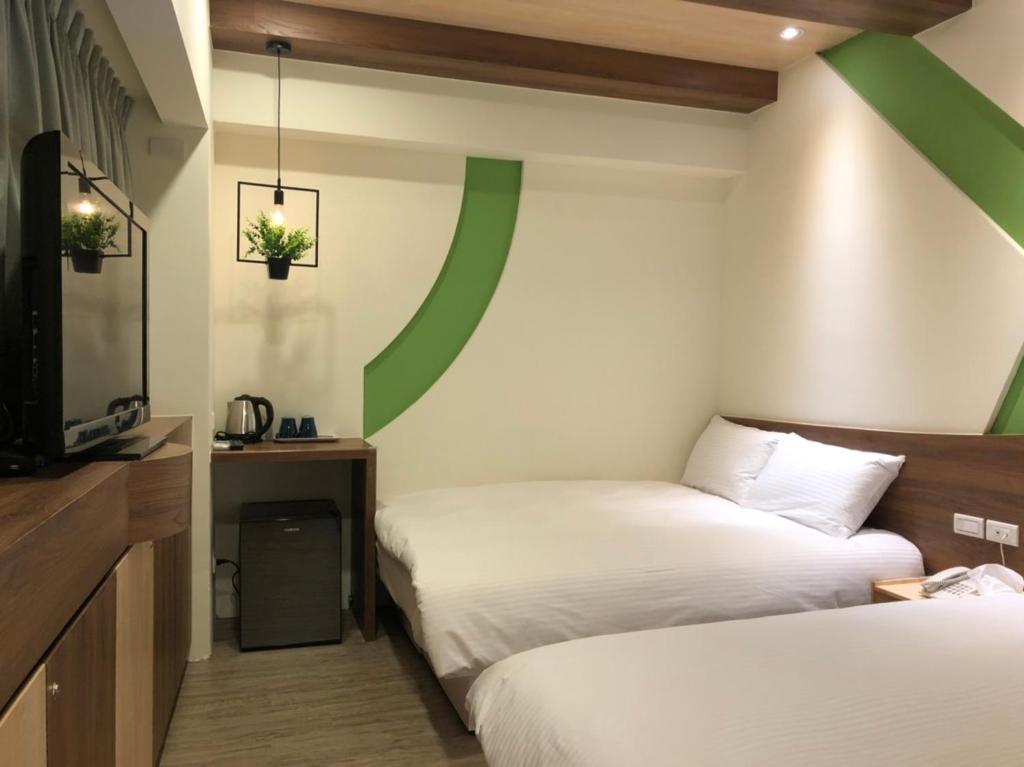 Postel nebo postele na pokoji v ubytování Haozhan Hotel