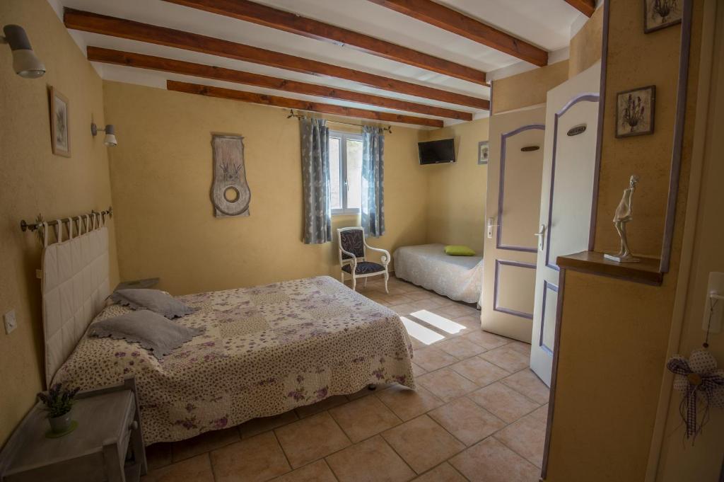 a bedroom with a bed and a living room at Chambres d&#39;Hôtes de Curnier in Bédoin