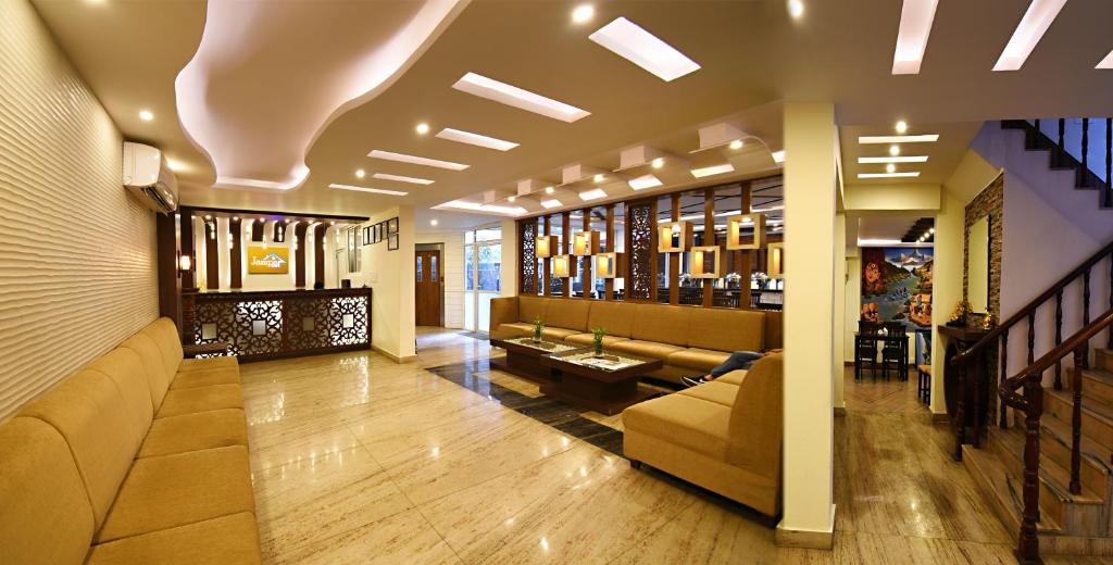 a lobby with couches and a table in a building at Hotel Jampa in Kathmandu