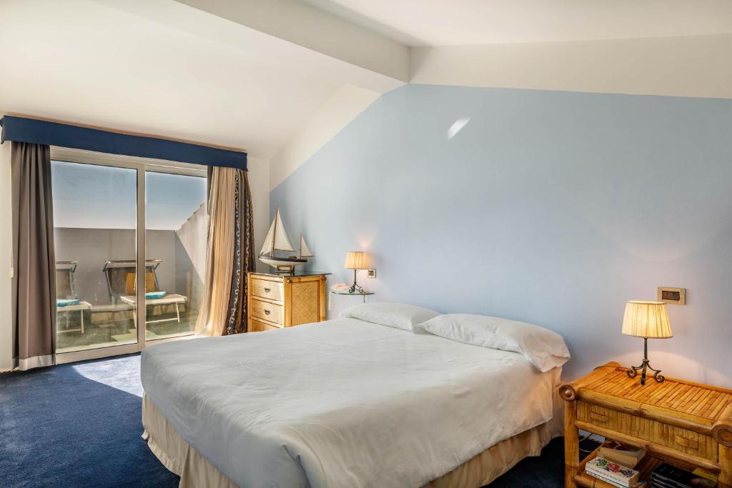 Cama ou camas em um quarto em Hotel Luna Lughente