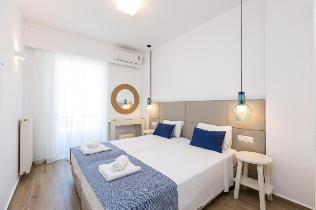 a bedroom with a bed with two towels on it at Eltina Hotel in Rethymno Town