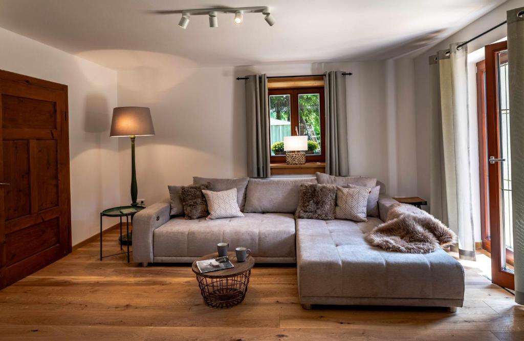 a living room with a couch and a table at Schneehaus Lodge in Ehrwald