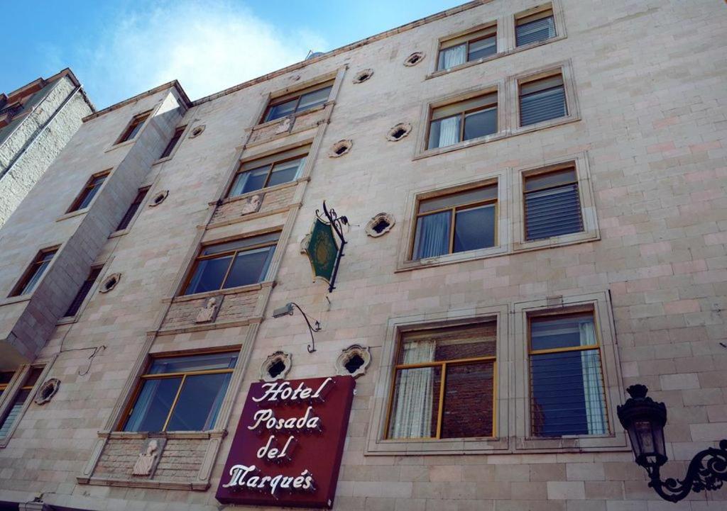 a building with a sign on the side of it at Posada del Marqués in San Juan de los Lagos