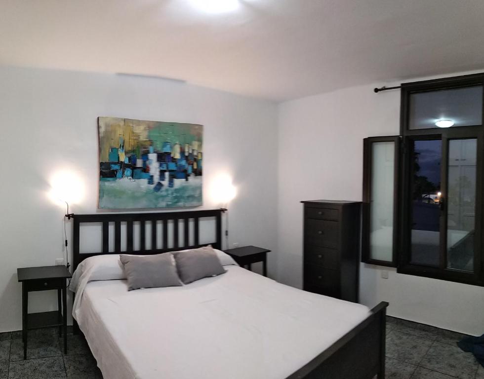A bed or beds in a room at Central Seaview Apartment Puerto del Carmen