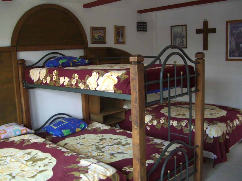 Postel nebo postele na pokoji v ubytování Hotel Hacienda Xico Inn