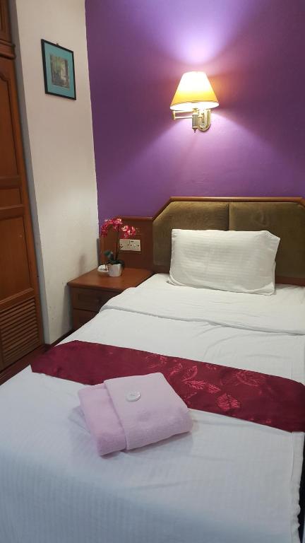 Postel nebo postele na pokoji v ubytování New Orchid Hotel Tuaran