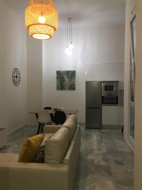 a living room with a couch and a table at Apartamento nuevo en casa tipo palacio in Cádiz