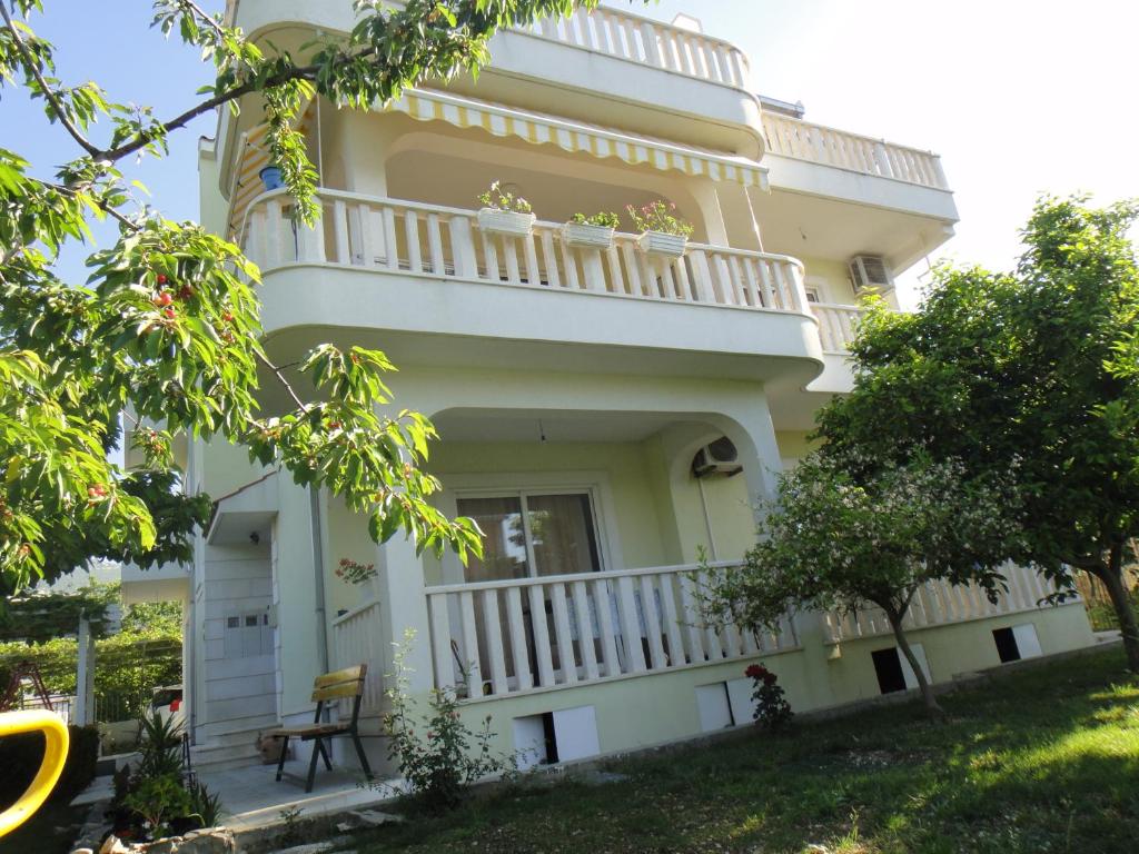 a large house with a balcony and a yard at Apartments Roko in Kaštela