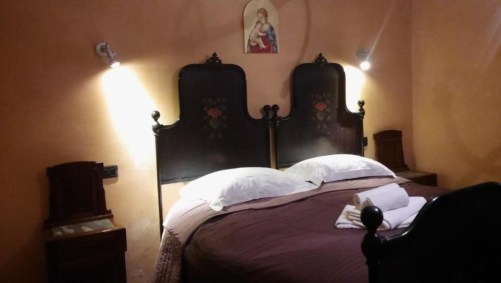 a bedroom with a large bed with two headboards at Agriturismo il Bacucco in Montecarotto