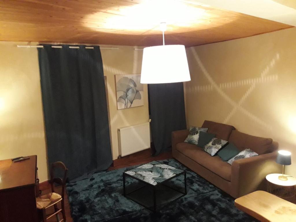a living room with a couch and a table at Chambres d'hôtes Belle Occitane in Tarascon-sur-Ariège