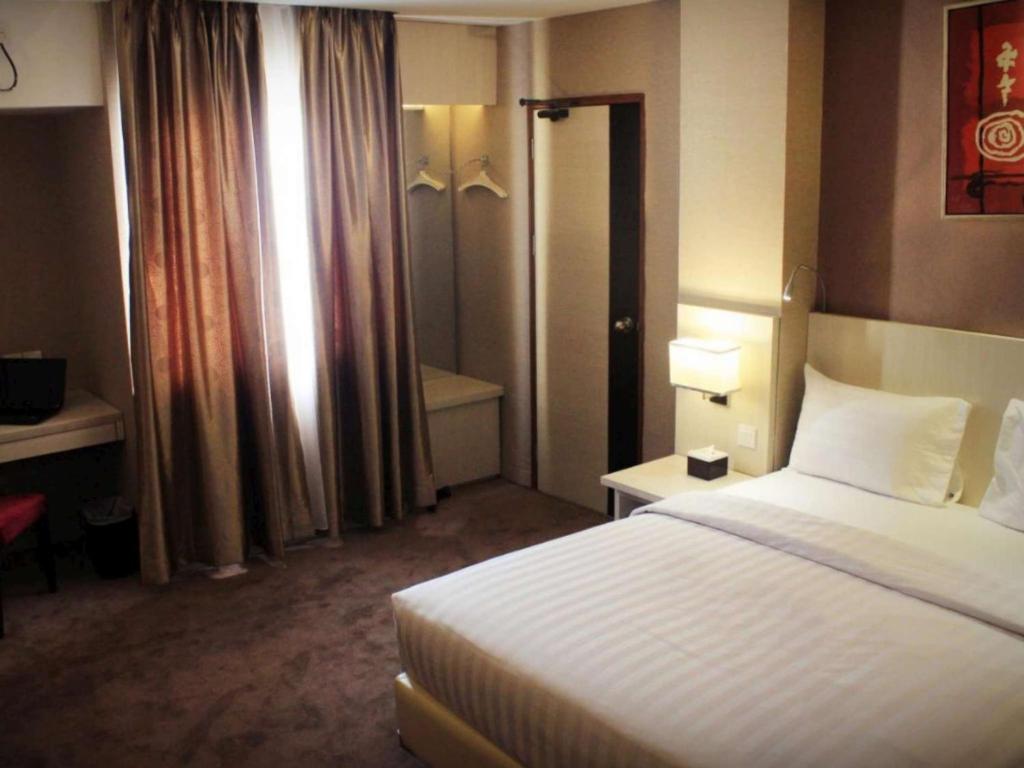 Postel nebo postele na pokoji v ubytování Biz Hotel Batam