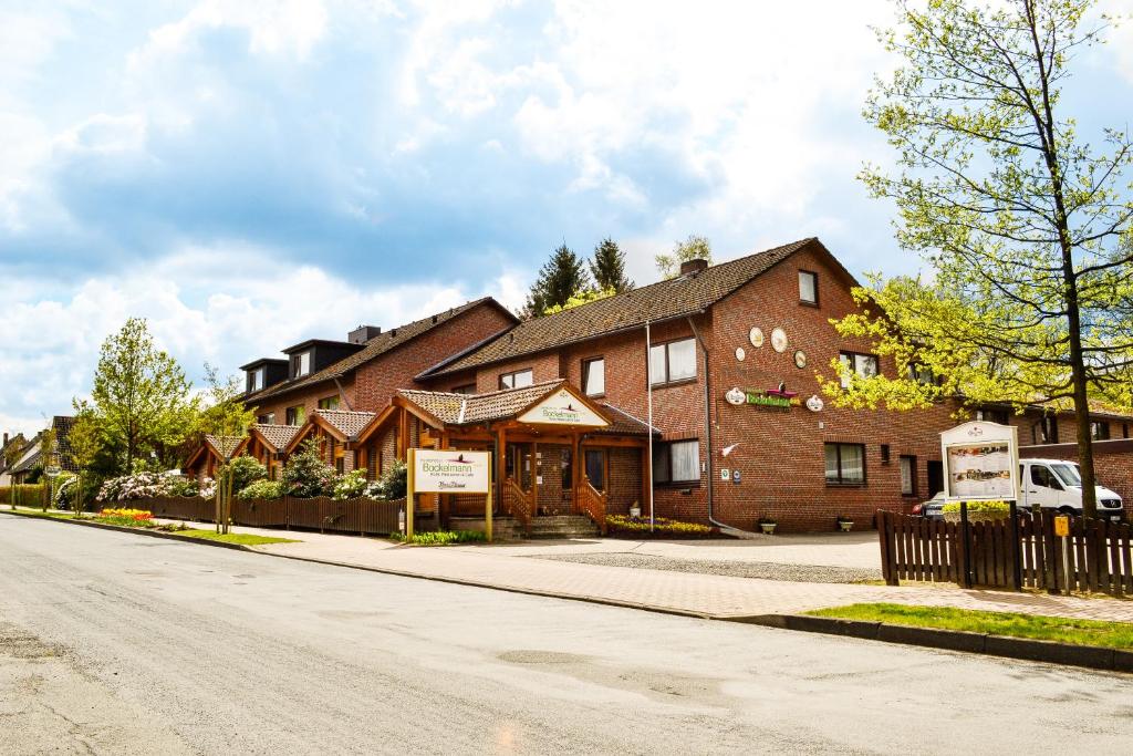 a large brick building on the side of a street at Hotel Bockelmann in Bispingen