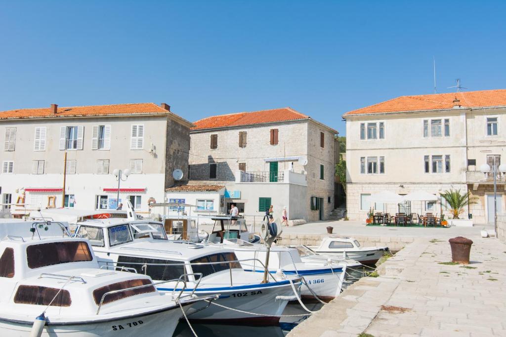 a group of boats docked in a harbor with buildings at Apartment Mileta Sali in Sali