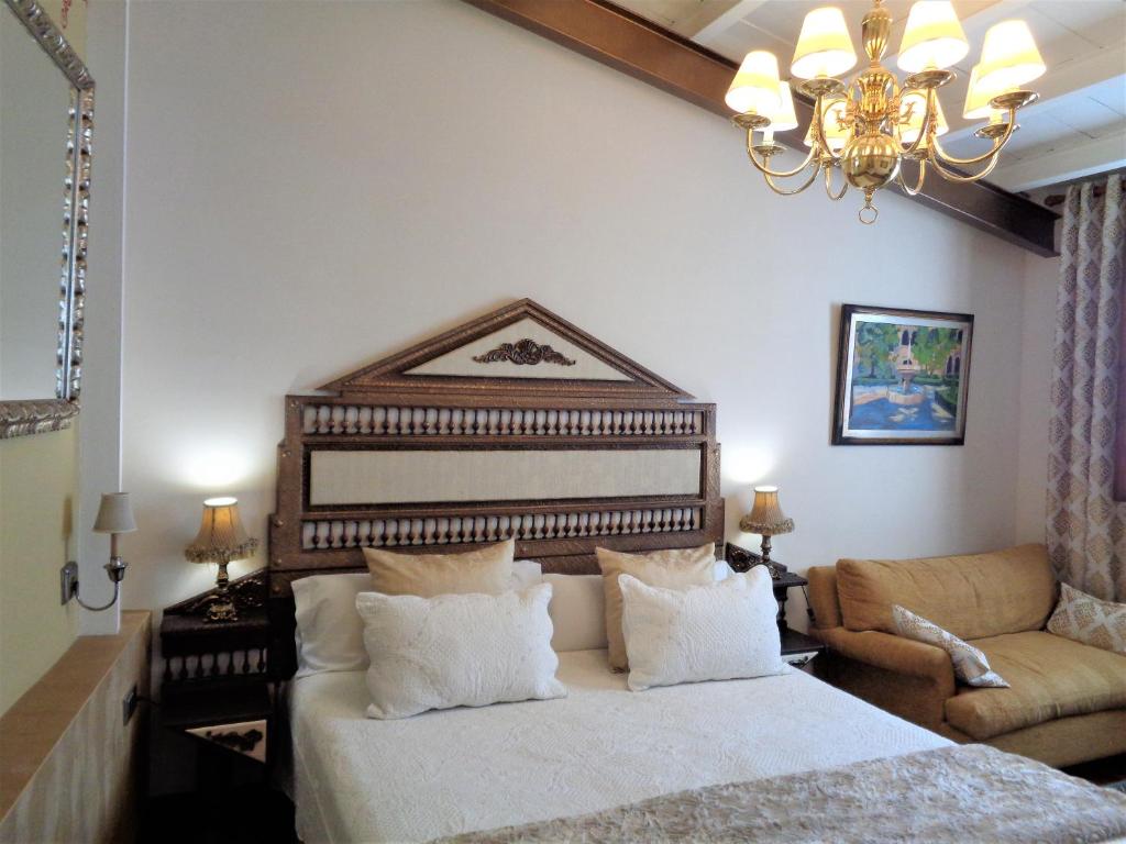 Postel nebo postele na pokoji v ubytování Hotel Boutique Nueve Leyendas