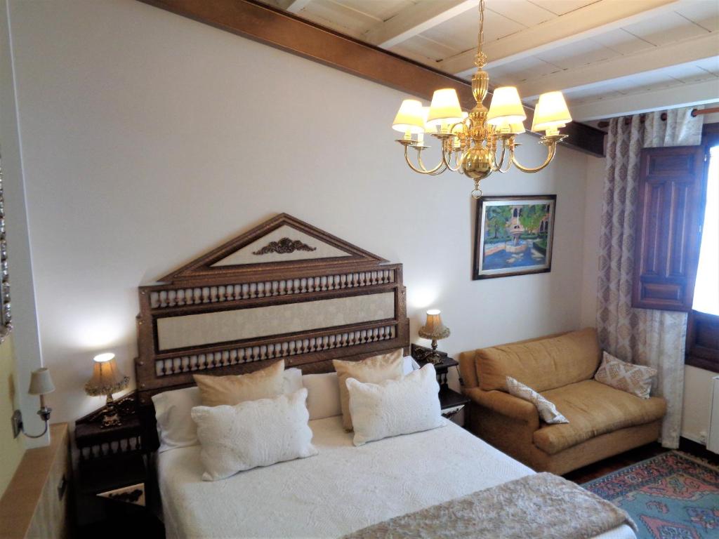 Postel nebo postele na pokoji v ubytování Hotel Boutique Nueve Leyendas