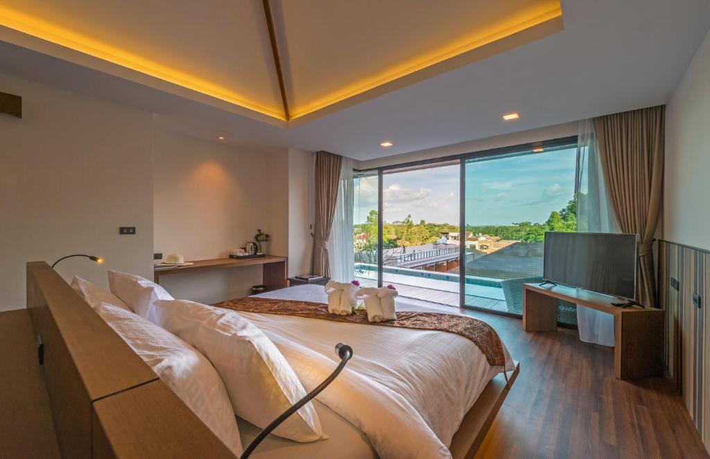 Postel nebo postele na pokoji v ubytování Cher​mantra​ Aonang​ Resort & Pool​ Suite