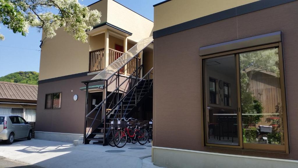 a group of bikes parked on the side of a building at Midori Guesthouse&Hostel in Tsushima