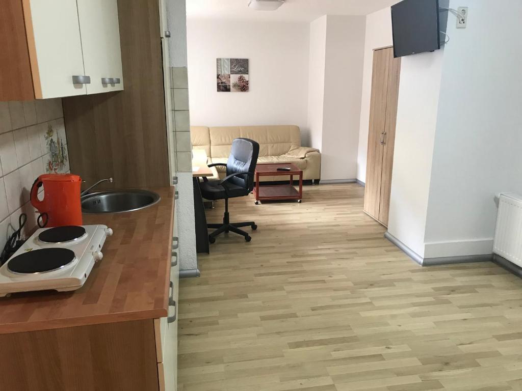 a kitchen with a sink and a desk in a room at Appartment Mittweida in Mittweida