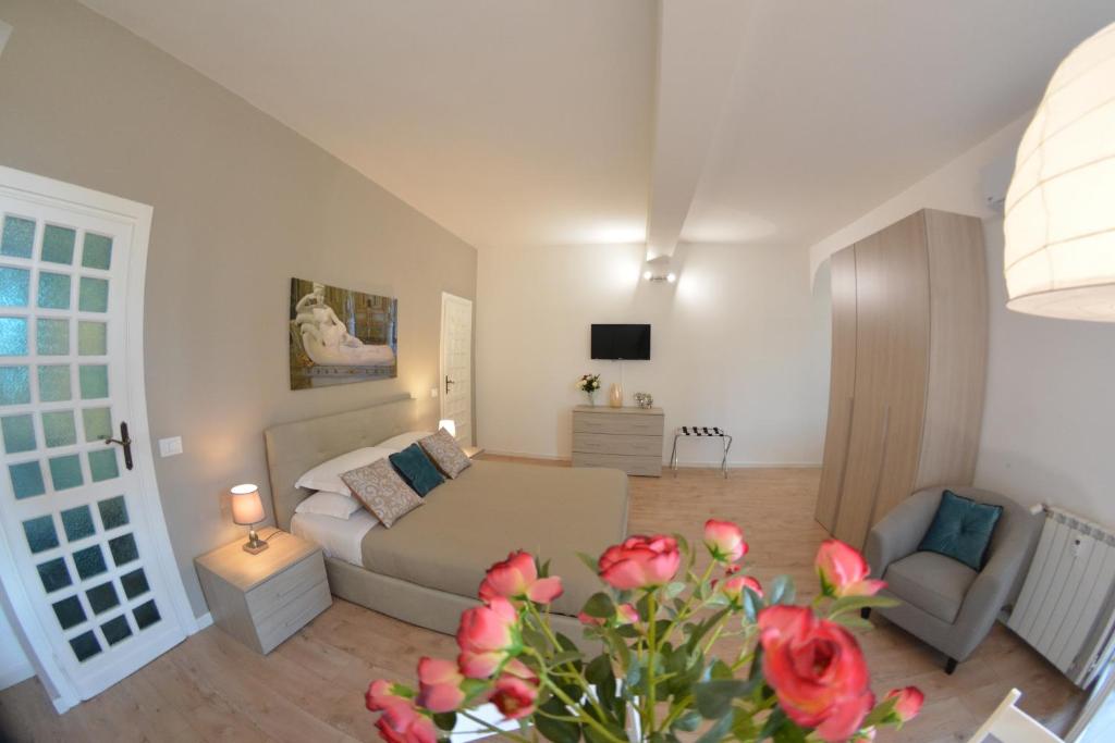 a living room with a couch and a chair at Petit Bijou de Rome Vatican-Trastevere in Rome