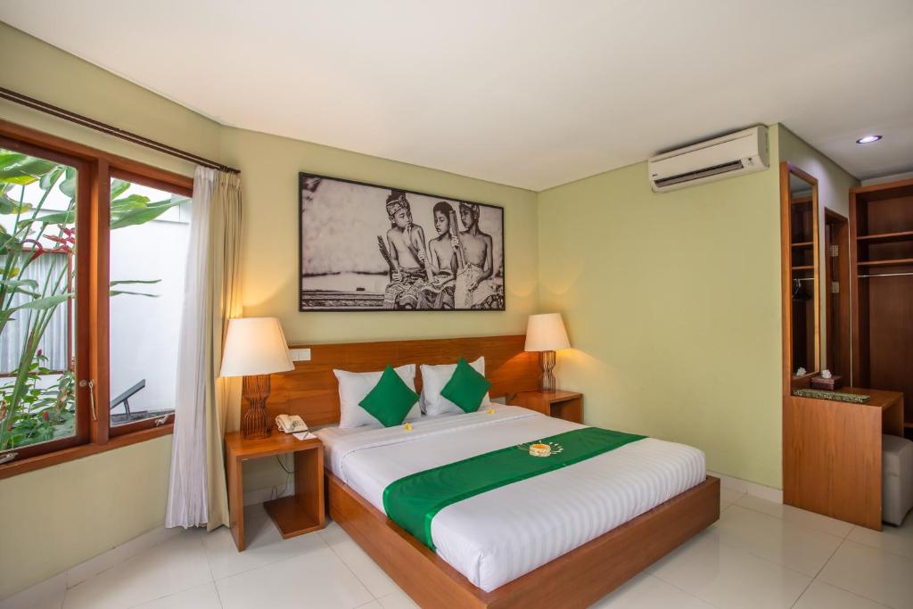 Postel nebo postele na pokoji v ubytování Bakung Ubud Resort and Villa