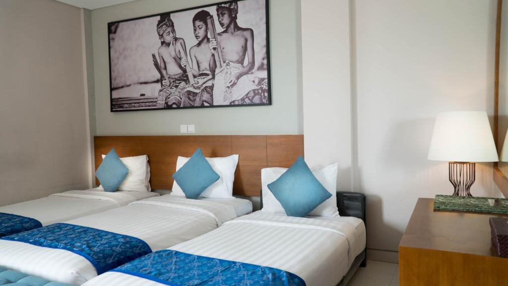 Postel nebo postele na pokoji v ubytování Bakung Ubud Resort and Villa