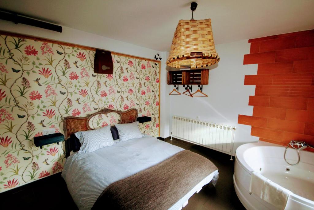 a bedroom with a bed and a bath tub at Loboratorio Rural, La Casa de al Lado in Casas del Abad