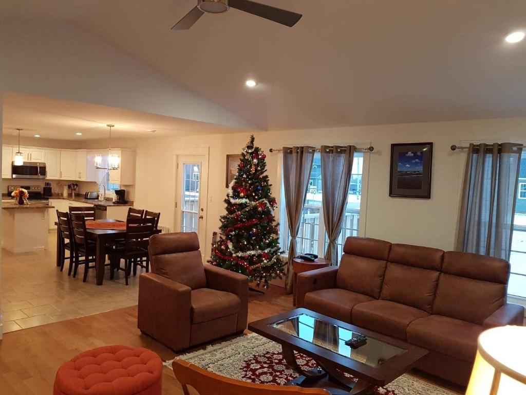 a living room with a christmas tree in it at By The Bay Stratford The Romeo Home in Stratford