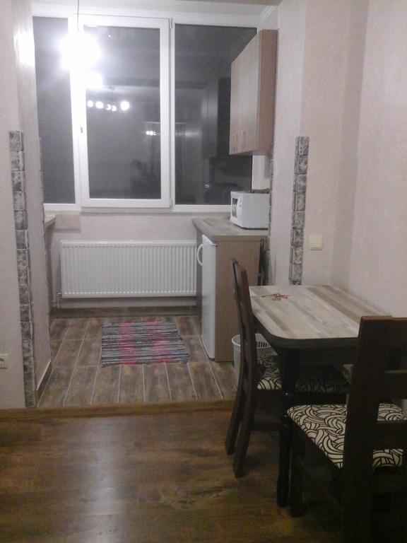 een keuken en eetkamer met een tafel en een raam bij Нова квартира in Ivano-Frankivsʼk