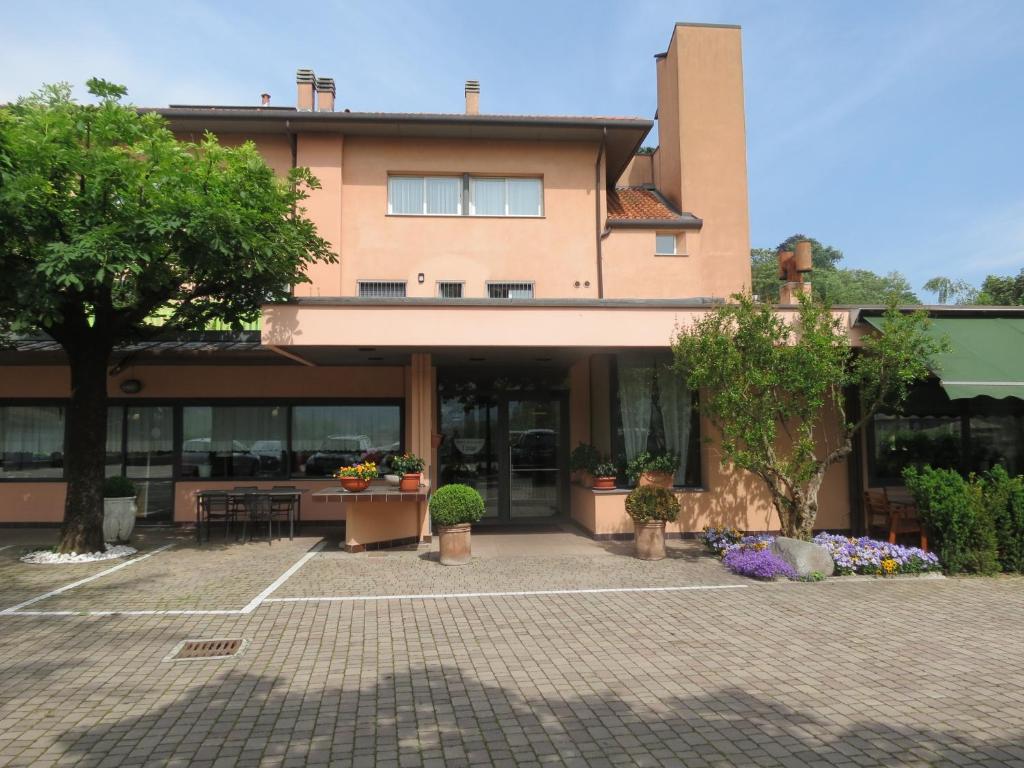 un edificio con muchas ventanas y árboles en Hotel Ristorante Fatur, en Cisano Bergamasco