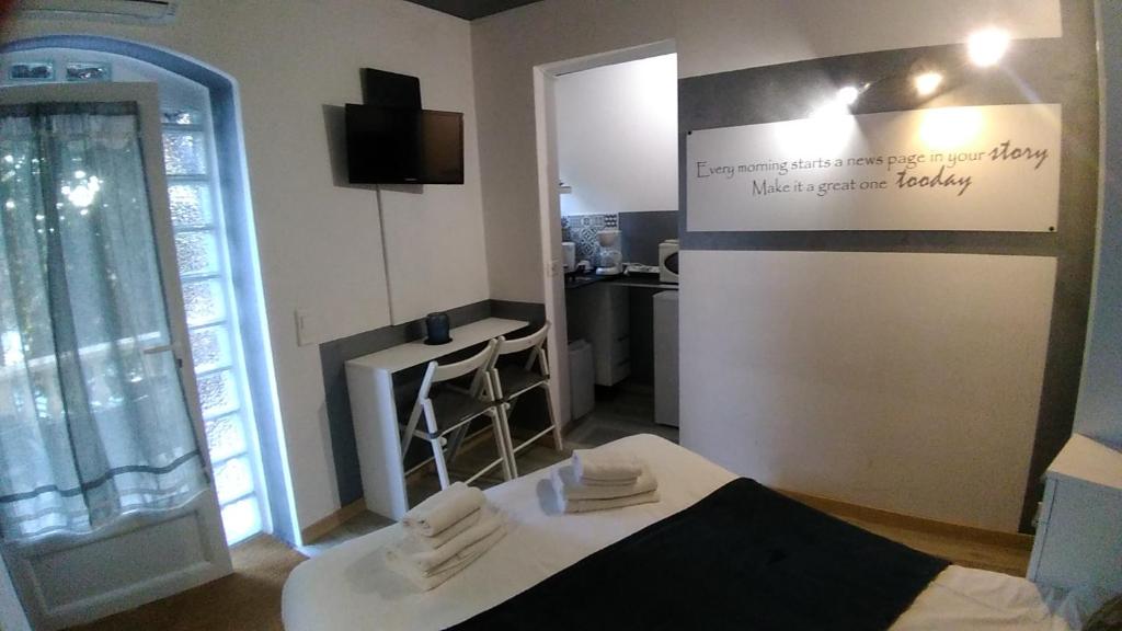 a room with a bed and a table with towels at Villa Azur Cap d'Ail in Cap d'Ail