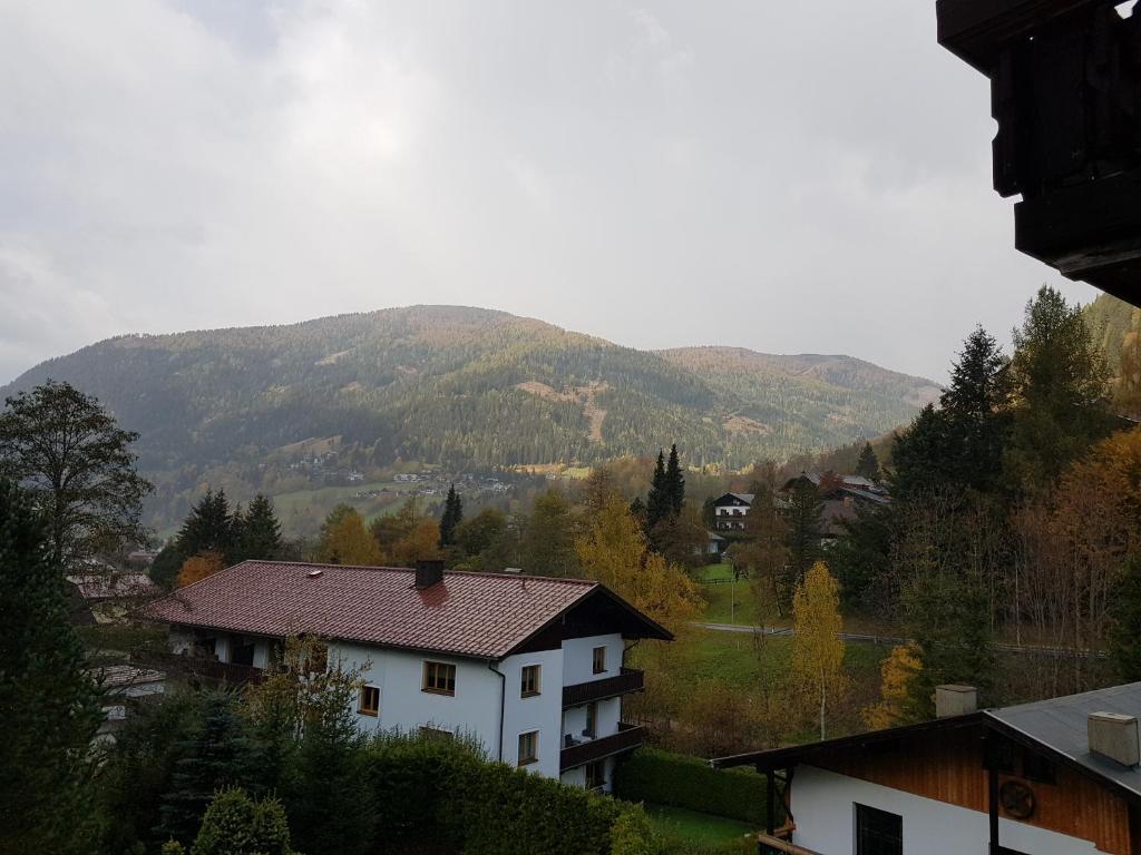 a white house with a mountain in the background at Haus Claudia by Globalimmoservice in Bad Kleinkirchheim