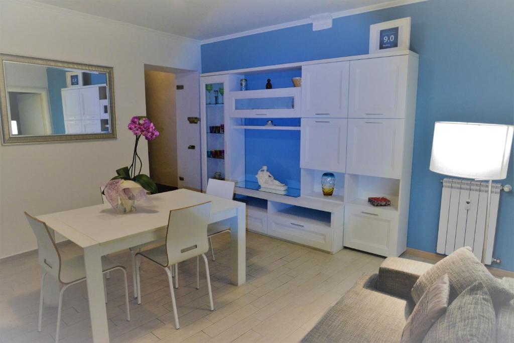 a dining room with a white table and a blue wall at Bijoux de Rome Apartment Vatican in Rome
