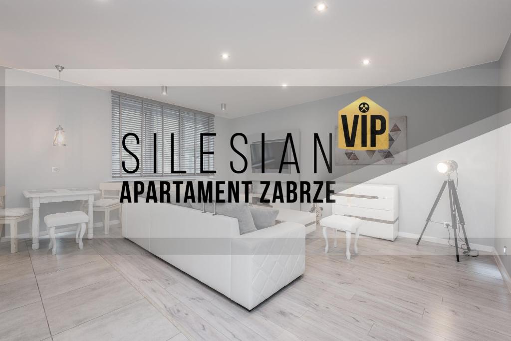a white living room with a white couch and a table at Apartament Silesian Vip in Zabrze