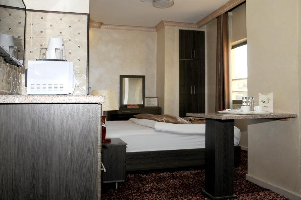 Krevet ili kreveti u jedinici u okviru objekta Olive Hotel Amman