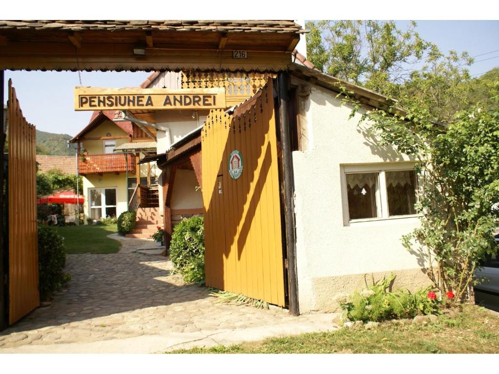 a yellow door on the side of a building at Pensiunea Andrei Sibiel in Sibiel