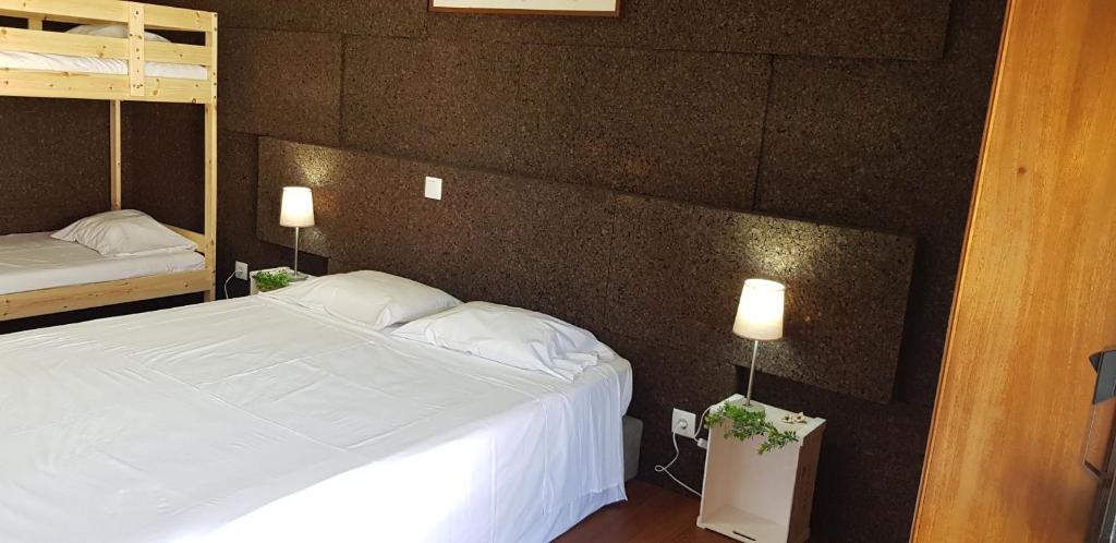 Postel nebo postele na pokoji v ubytování Residencial Dom Manuel