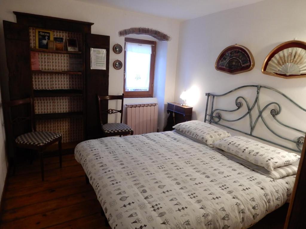 - une chambre avec un lit, deux chaises et une fenêtre dans l'établissement Il Borgo della Colomba, à Fosdinovo