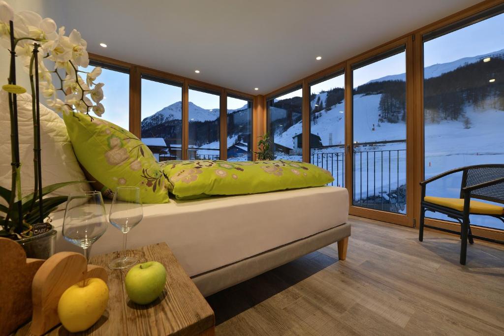 a living room filled with furniture and a balcony at Appartamenti Astra in Livigno