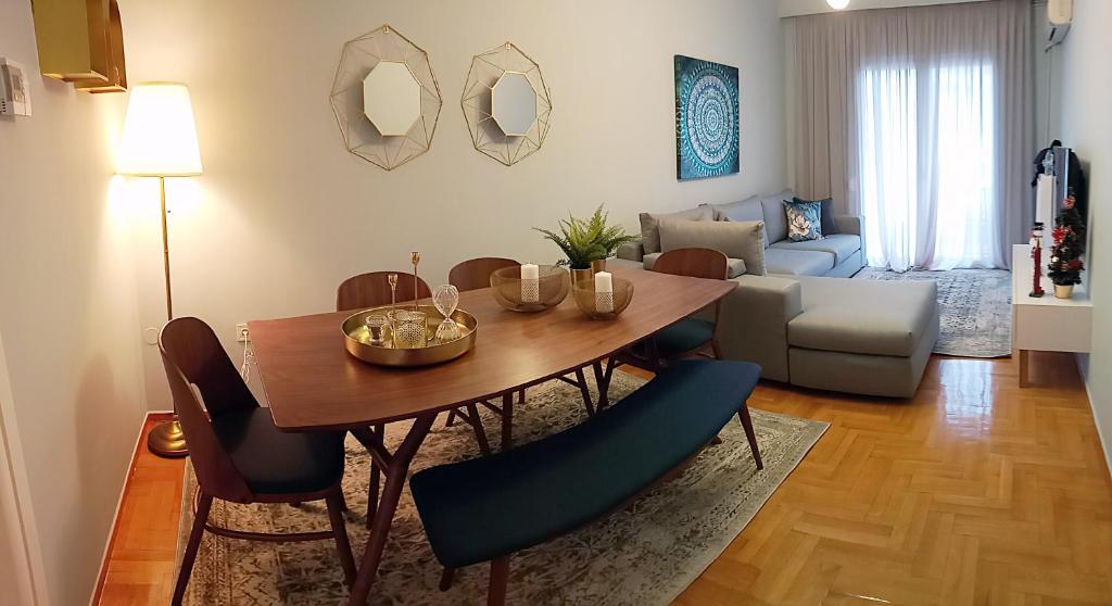 a living room with a dining room table and chairs at Royal deluxe Apt.(must) in Thessaloniki