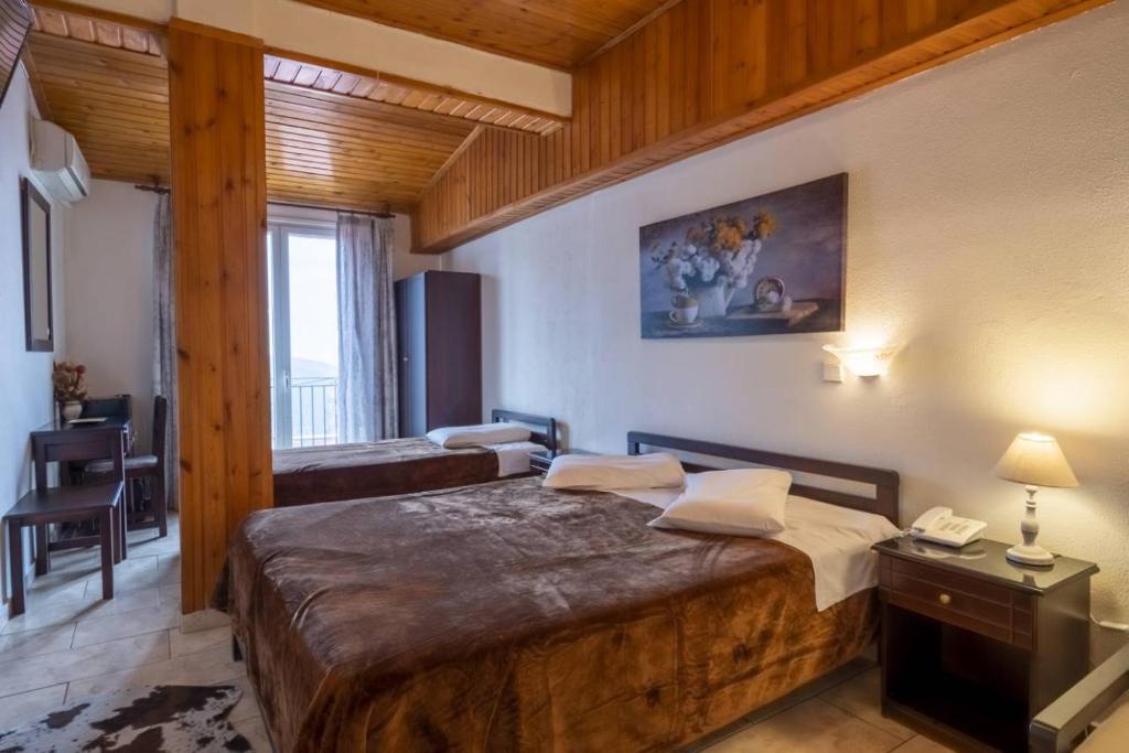 a bedroom with a large bed in a room at Hotel Lefas in Delphi