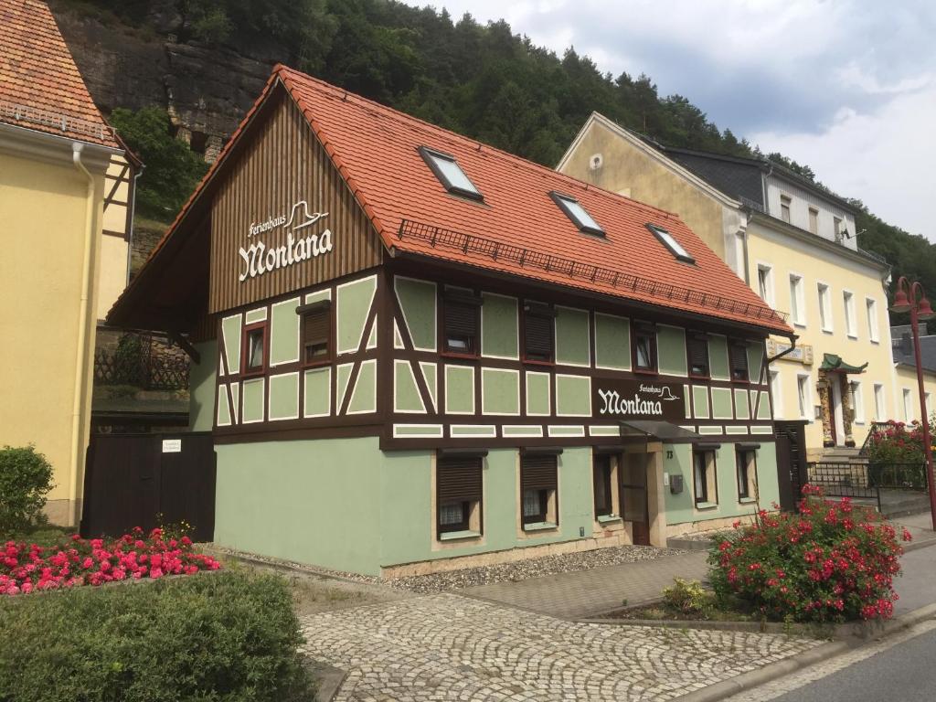 a building with a red roof on a street at Ferienhaus Montana in Bad Schandau