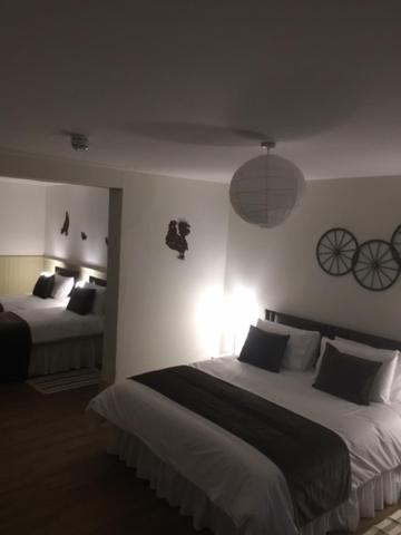 a bedroom with two beds in a room with bikes on the wall at Good Intent Rooms in Waltham Abbey