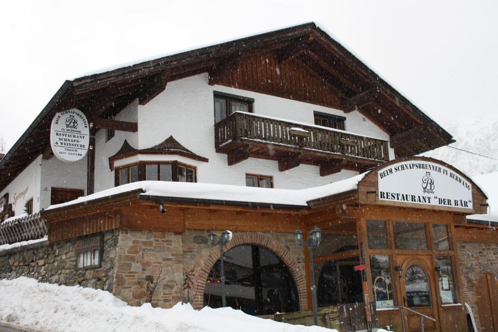 a snow covered building with a balcony on top of it at Bären Appartements in Berwang