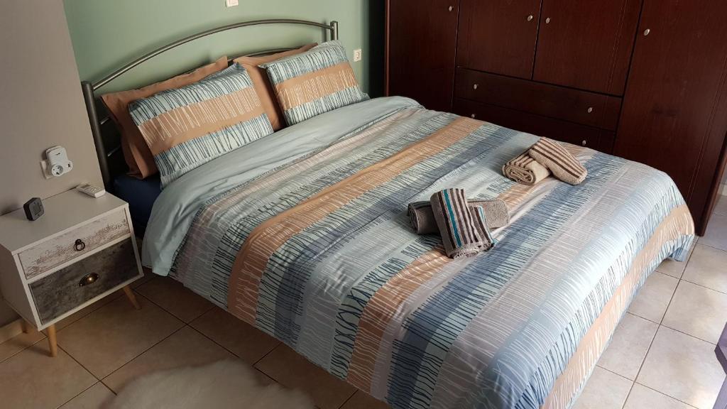 a bed with two pillows on it in a bedroom at Feels like your home in Alexandroupoli