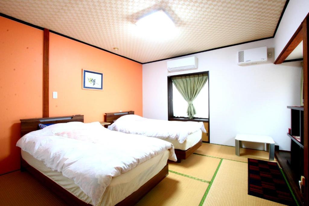 Postel nebo postele na pokoji v ubytování Ryokan Kibun