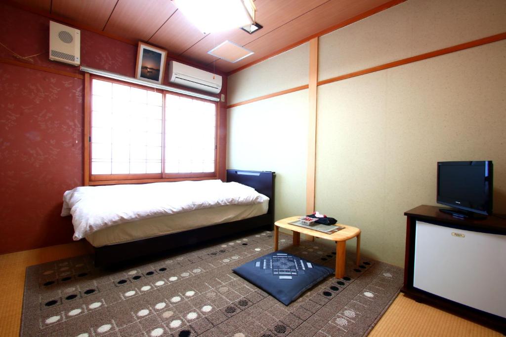 Postel nebo postele na pokoji v ubytování Ryokan Kibun