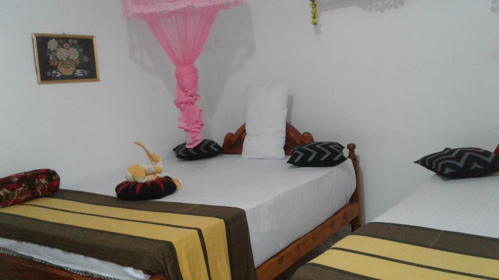 Postel nebo postele na pokoji v ubytování Kalana Homestay